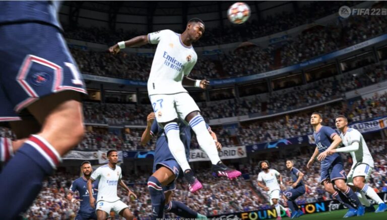 Real Madrid player leaping to head the ball amid Paris Saint-Germain defenders in an EA Sports FIFA 23 match