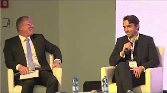 Two suited speakers seated in armchairs during Cyabra’s Cybertech 2022 discussion on foreign interference in social media
