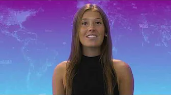 Smiling presenter against a gradient world map background during a segment on protecting against disinformation