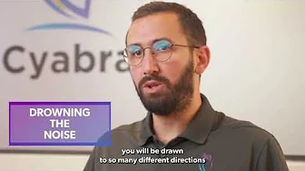 Man with beard and glasses talking during Cyabra interview titled 'Drowning the Noise'
