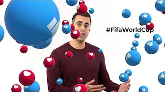 Presenter in burgundy sweater surrounded by floating blue spheres with like and heart icons and the hashtag FifaWorldCup