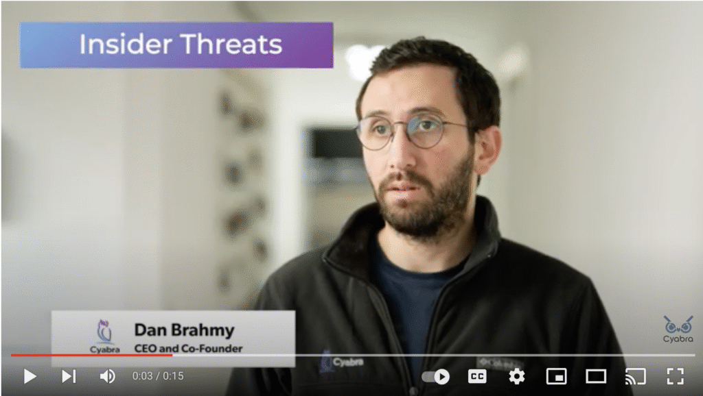 Man with dark hair and glasses speaking in a Cyabra video about insider threats, purple title bar reading Insider Threats