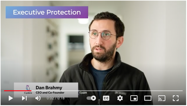Man with glasses speaking in a video; purple gradient banner at top left reads 'Executive Protection', with a lower-third bar displaying the speaker's name and title