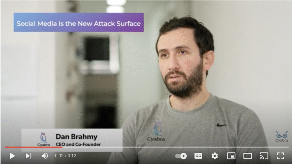Person speaking in a Cyabra video titled 'Social Media is the New Attack Surface' with text overlay and company branding
