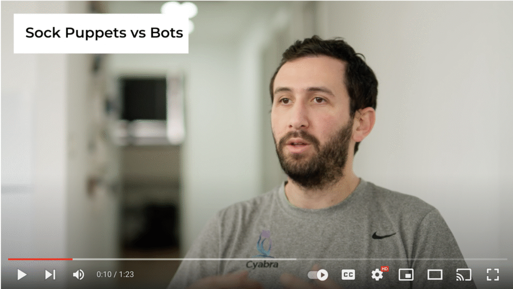 Thumbnail from a Cyabra video showing a bearded man speaking, with on-screen text reading “Sock Puppets vs Bots”