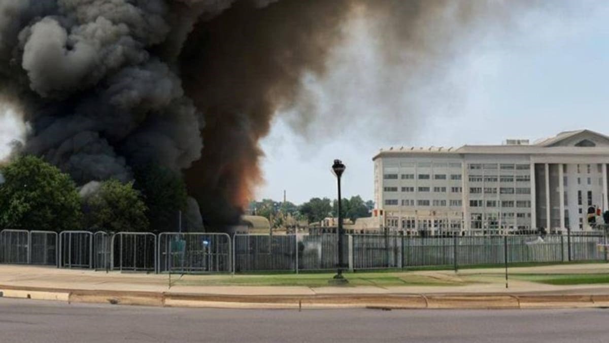 AI-generated scene of thick black smoke rising beside the Pentagon, illustrating a fabricated explosion used in a disinformation campaign