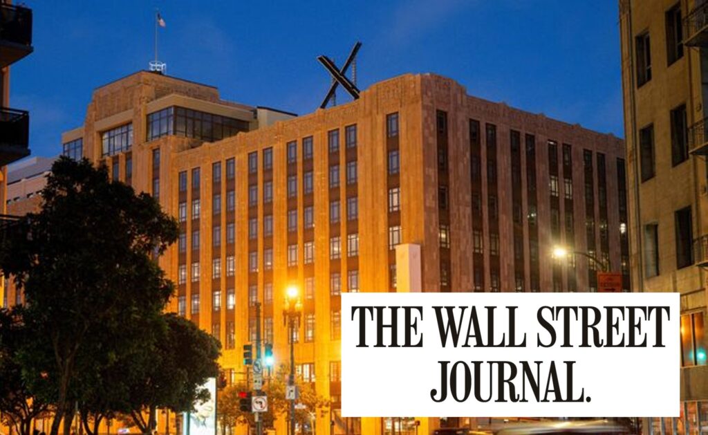 X headquarters building in San Francisco lit at dusk with large X logo on the roof