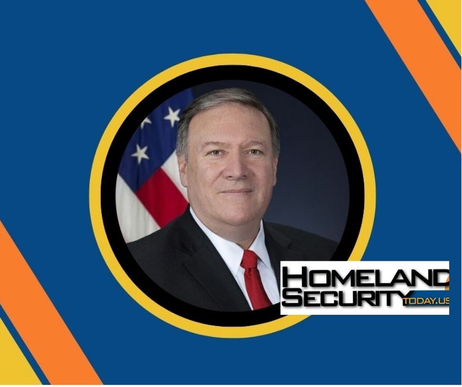 Official portrait of a man in suit and red tie set in a circular frame against a blue background with orange and yellow accents and the Homeland Security Today logo