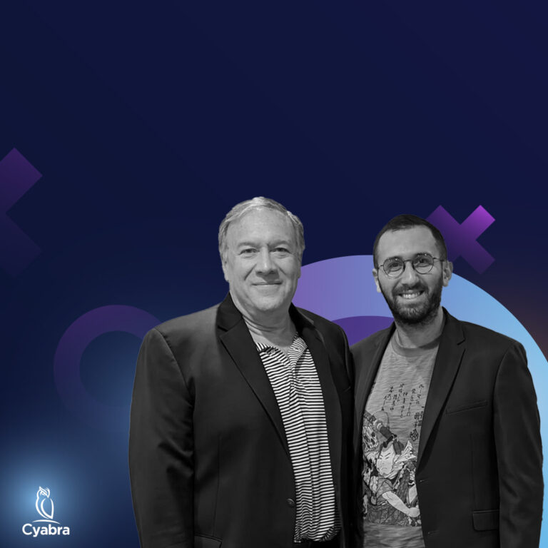 Two men wearing jackets smiling against a dark blue backdrop with abstract purple shapes and Cyabra owl logo