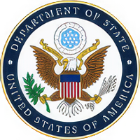 U.S. Department of State seal featuring a bald eagle clutching an olive branch and arrows, surrounded by navy text ring