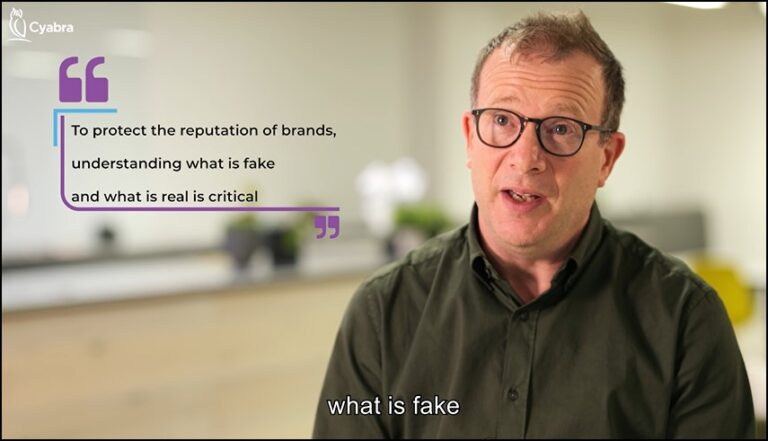 Man with glasses speaking in a blurred office environment, alongside a Cyabra-branded quote that reads “To protect the reputation of brands, understanding what is fake and what is real is critical”