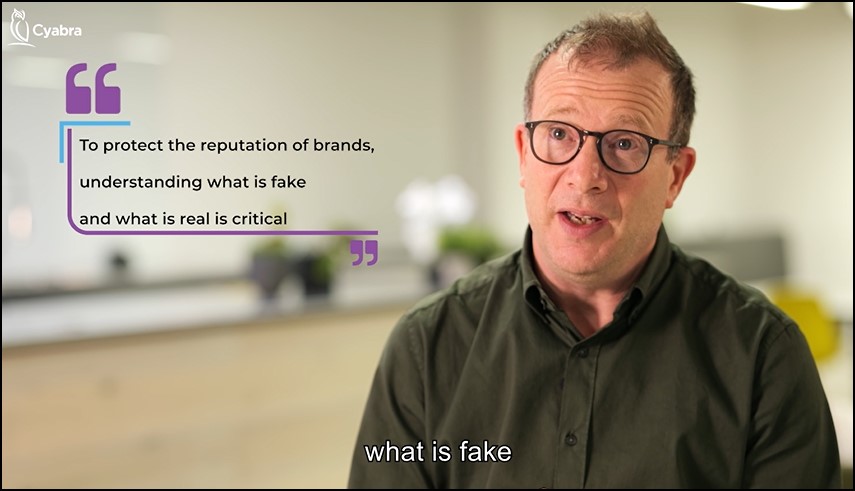 Man with glasses speaking in a blurred office environment, alongside a Cyabra-branded quote that reads “To protect the reputation of brands, understanding what is fake and what is real is critical”