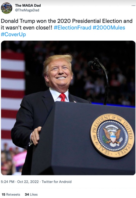 Tweet from user @TheMagaDad asserting victory in the 2020 U.S. election and alleging fraud, with a smiling man in a dark suit and red tie standing behind a podium bearing the U.S. presidential seal at a rally